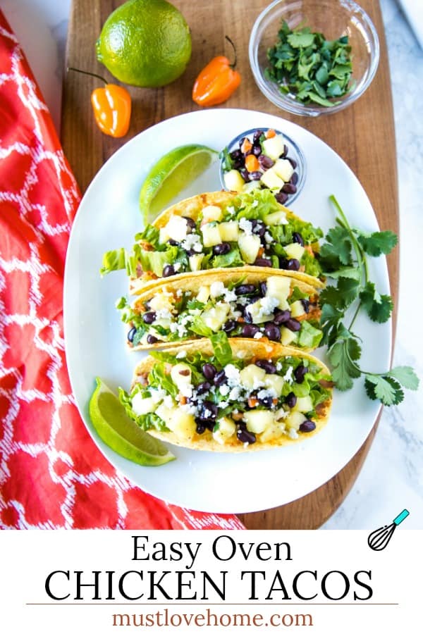 Easy Oven Chicken Tacos are seasoned shredded chicken stuffed into refried bean smeared crunchy shells and topped with cheese. Baked easy in the oven then loaded with spoonfuls of fresh pineapple salsa. #mustlovehomecooking #tacorecipes