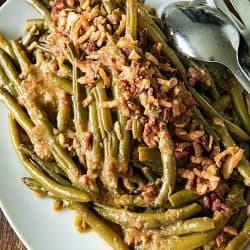 Super tender, loaded with flavor Southern-style green bean recipe with bacon, crispy onions and lots of seasonings. #mustlovehomecooking #slowcookerrecipes #greenbeanrecipe