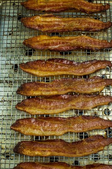 Crispy, smoked bacon cooked perfect every time right in the oven. Big batch bacon cooking with no flipping, no mess and no splatter.