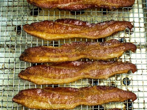 Crispy, smoked bacon cooked perfect every time right in the oven. Big batch bacon cooking with no flipping, no mess and no splatter. #mustlovehomecooking