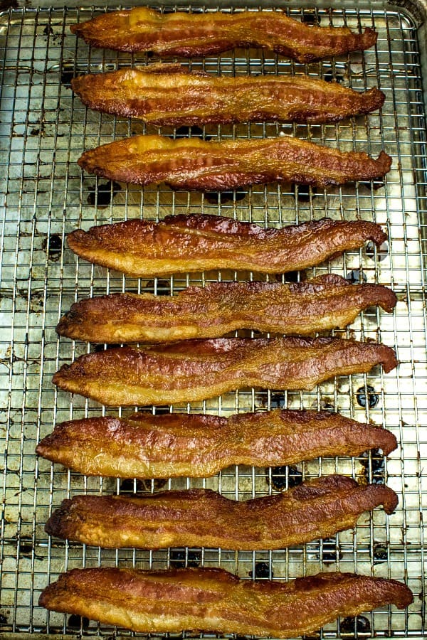 Crispy, smoked bacon cooked perfect every time right in the oven. Big batch bacon cooking with no flipping, no mess and no splatter. #mustlovehomecooking