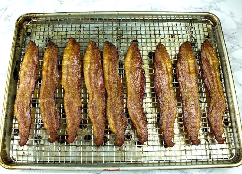 Crispy, smoked bacon cooked perfect every time right in the oven. Big batch bacon cooking with no flipping, no mess and no splatter. 