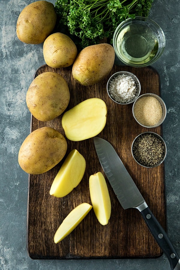 Crispy Roasted Potato Wedges - easy oven baked golden brown potatoes with olive oil, garlic and parmesan cheese. #mustlovehomecooking #ovenpotatorecipes