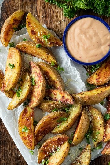 Crispy Roasted Potato Wedges - easy oven baked golden brown potatoes with olive oil, garlic and parmesan cheese. #mustlovehomecooking #ovenpotatorecipes