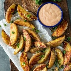 Crispy Roasted Potato Wedges - easy oven baked golden brown potatoes with olive oil, garlic and parmesan cheese. #mustlovehomecooking #ovenpotatorecipes