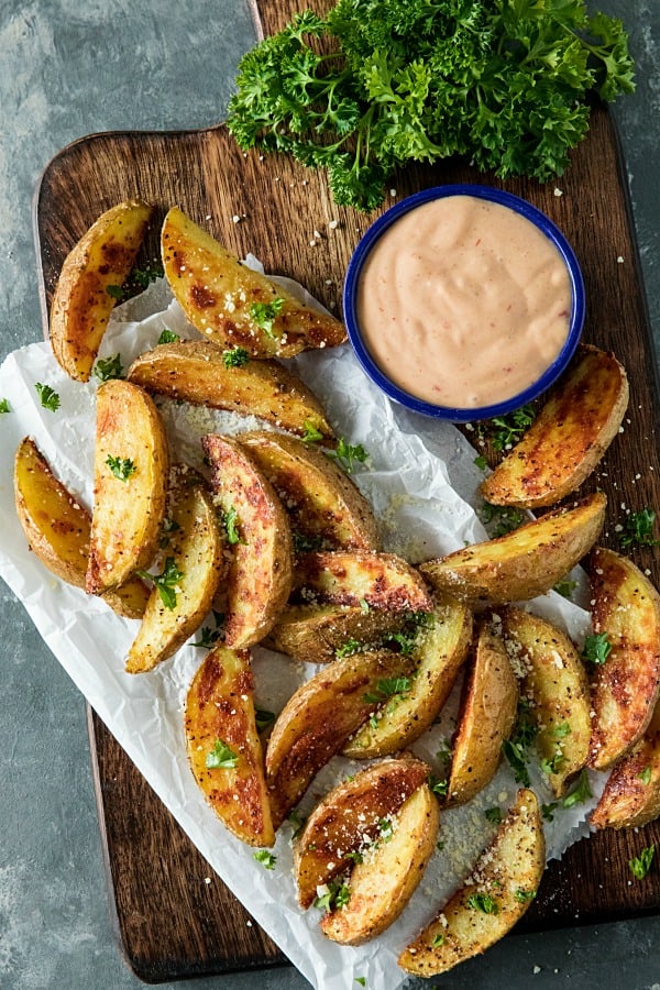 Crispy Roasted Potato Wedges - easy oven baked golden brown potatoes with olive oil, garlic and parmesan cheese. #mustlovehomecooking #ovenpotatorecipes