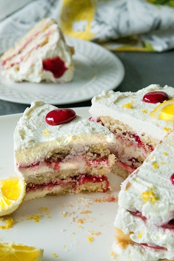 A sweet, fluffy indulgence, this Raspberry lemon Icebox Cake is simple to prep in minutes with whipped cream, raspberries and buttery shortbread cookies.#mustlovehomecooking