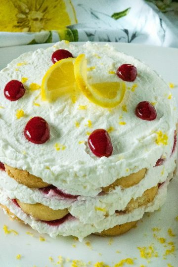 A sweet, fluffy indulgence, this Raspberry lemon Icebox Cake is simple to prep in minutes with whipped cream, raspberries and buttery shortbread cookies.#mustlovehomecooking