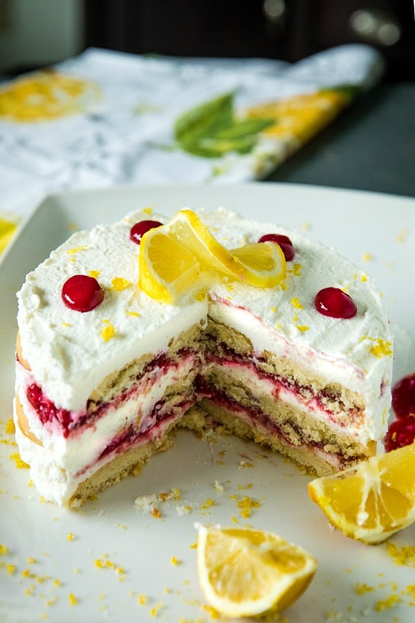 A sweet, fluffy indulgence, this Raspberry lemon Icebox Cake is simple to prep in minutes with whipped cream, raspberries and buttery shortbread cookies.