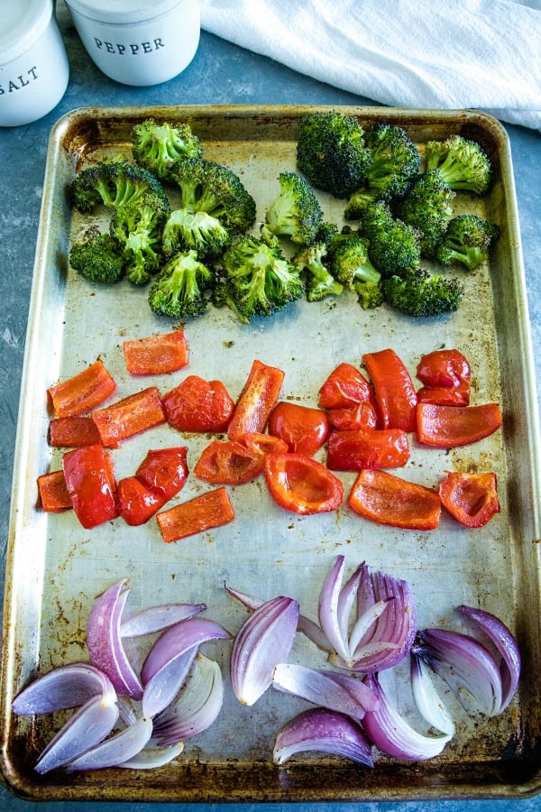 Broccoli, peppers and onions on sheet pan ready for roasting