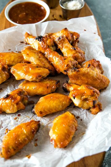 Baked spicy apricot chicken wings brushed with a spicy glaze of apricot preserves, brown sugar and zesty seasonings. #mustlovehomecooking #chickenwingrecipes