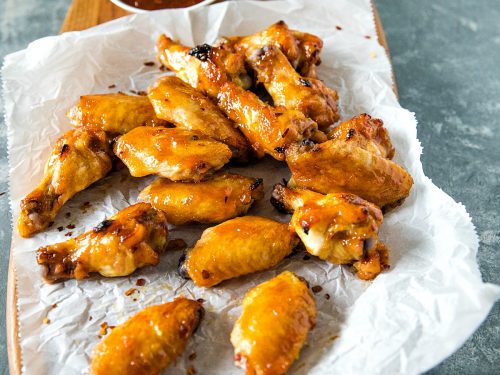 Baked spicy apricot chicken wings brushed with a spicy glaze of apricot preserves, brown sugar and zesty seasonings. #mustlovehomecooking #chickenwingrecipes