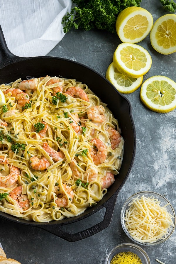 Lemon Pepper Shrimp Alfredo made with lemony seasoned shrimp, fettuccine and an addictive cheesy cream sauce. A busy weeknight favorite! #mustlovehomecooking