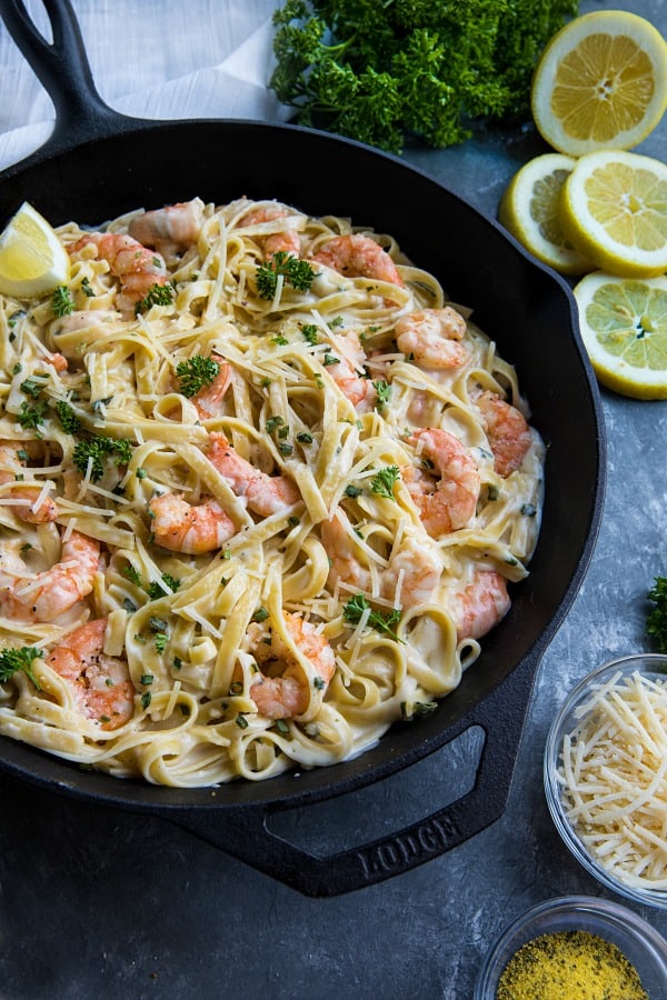 Lemon Pepper Shrimp Alfredo made with lemony seasoned shrimp, fettuccine and an addictive cheesy cream sauce. A busy weeknight favorite! #mustlovehomecooking