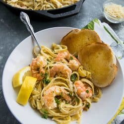 Lemon Pepper Shrimp Alfredo made with lemony seasoned shrimp, fettuccine and an addictive cheesy cream sauce. A busy weeknight favorite! #mustlovehomecooking