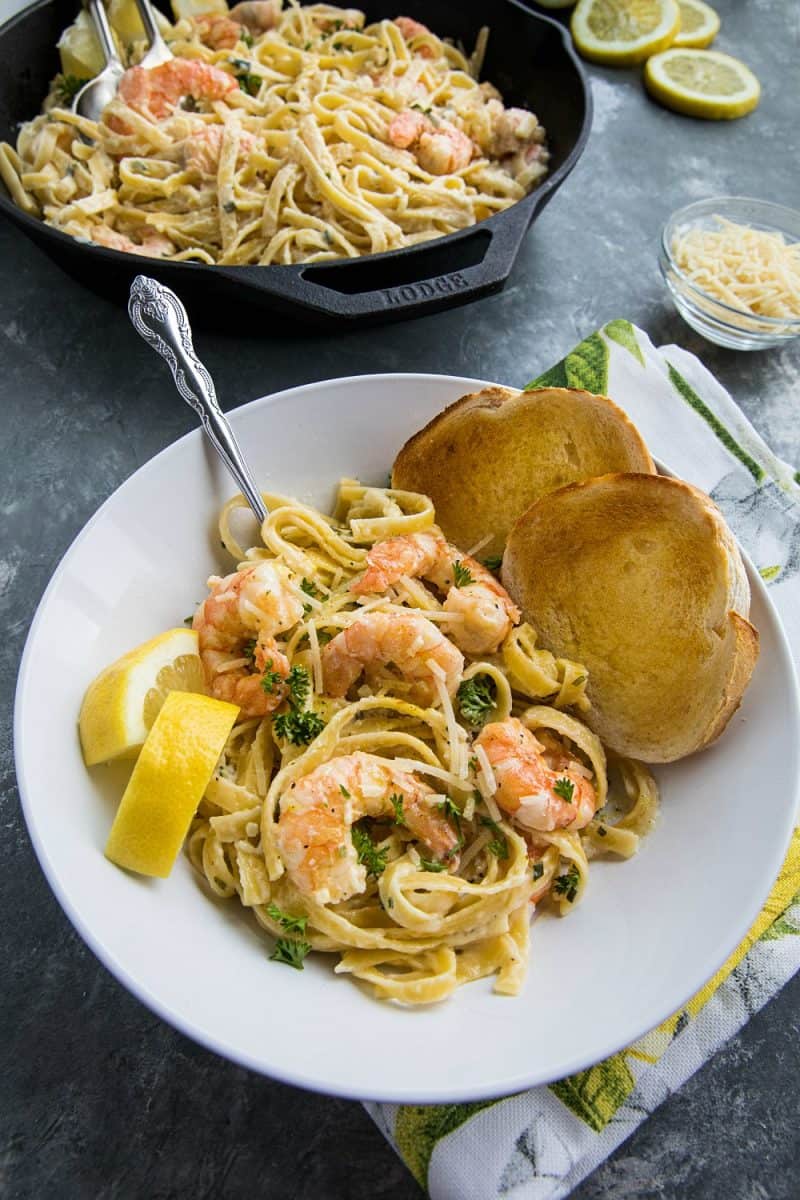 Lemon Pepper Shrimp Alfredo made with lemony seasoned shrimp, fettuccine and an addictive cheesy cream sauce. A busy weeknight favorite! #mustlovehomecooking