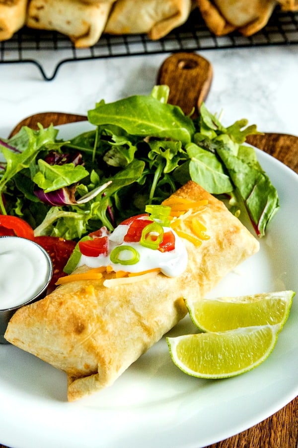 Easy Oven Chicken Chimichangas with seasoned rice, salsa and cheese are a healthy, lighter twist on the Mexican classic. #mustlovehomecooking
