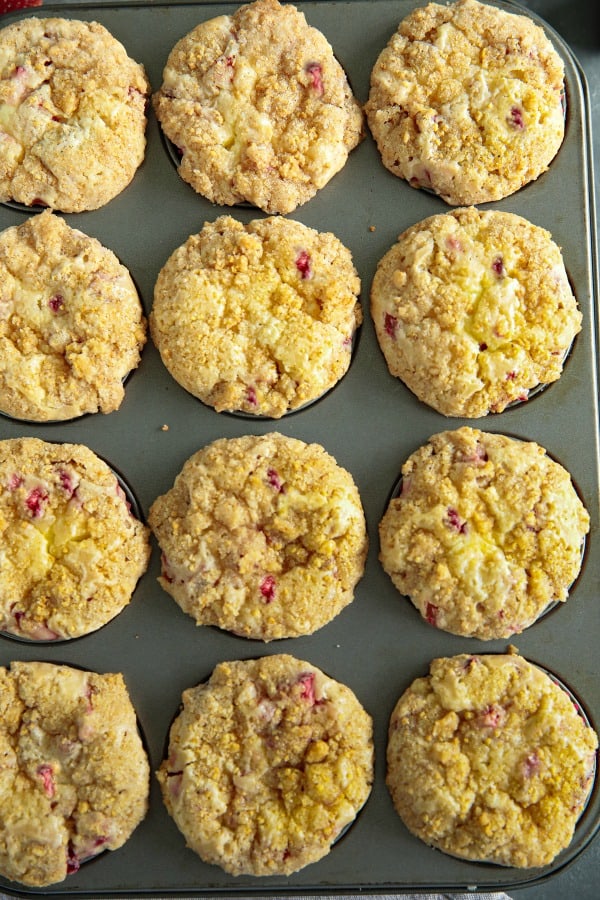 Strawberry Cheesecake Muffins are studded with fresh strawberries, have a luscious swirl of cheesecake in the middle and are topped with a thick layer of buttery streusel. Life changing! #mustlovehomecooking