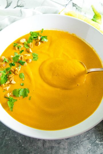 Silky smooth Instant Pot Thai Carrot Soup, with peanut butter, coconut milk and vegetable stock is light, spicy and naturally a little bit sweet. #mustlovehomecooking