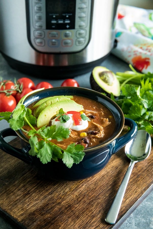 Instant Pot Mexican Chicken Soup with black beans, tomatoes, green chilies and chipotle peppers is a deliciously zesty and comforting meal made quick and easy in your pressure cooker. #mustlovehomecooking