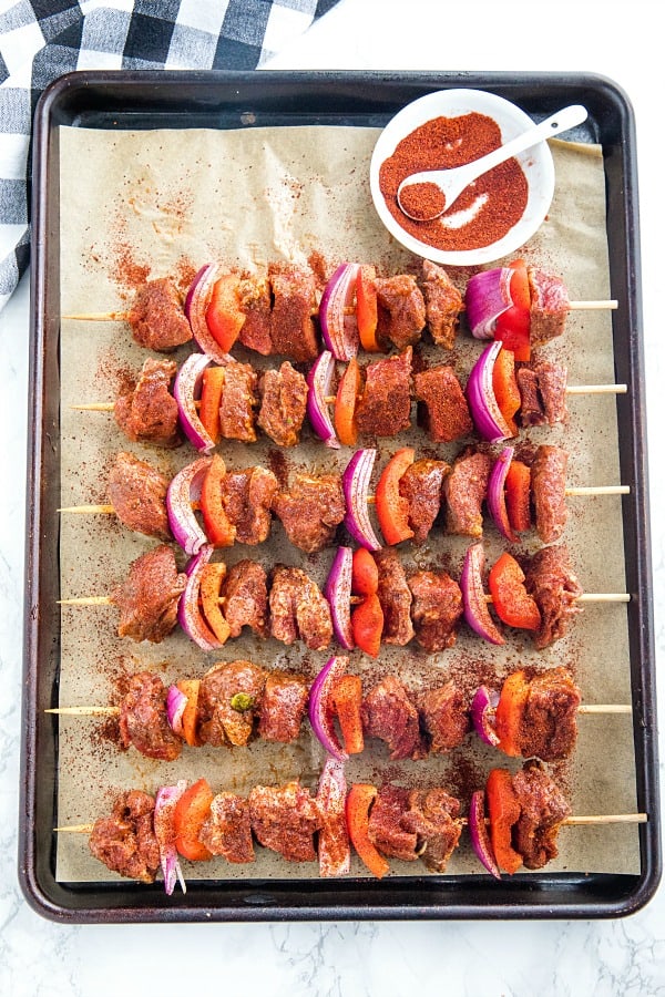 Beef, peppers and onion on skewers ready for grilling.