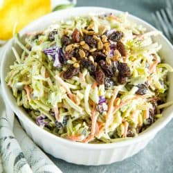 Easy Broccoli Slaw is a healthy, crunchy and sugar free blend of shredded broccoli, raisins and pepitas with an irresistible sweet and sour dressing. #mustlovehomecooking