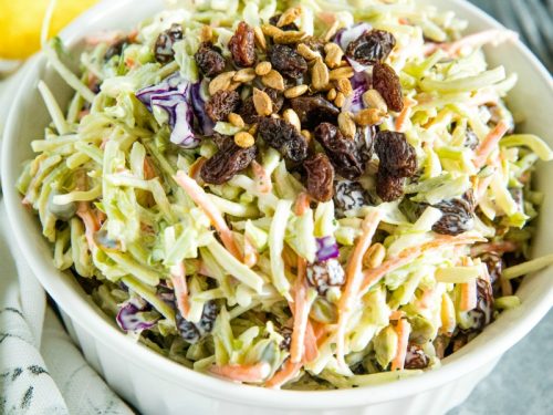 Easy Broccoli Slaw is a healthy, crunchy and sugar free blend of shredded broccoli, raisins and pepitas with an irresistible sweet and sour dressing. #mustlovehomecooking