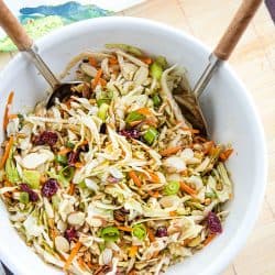 Midwest Cabbage Salad is a cold and crisp side dish made with shredded cabbage, green onions, dried cranberries, almonds. sunflower seeds and sweet dressing is fresh, healthy and stays crunchy in the refrigerator for several days! #mustlovehomecooking