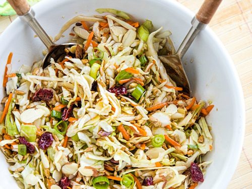 Midwest Cabbage Salad is a cold and crisp side dish made with shredded cabbage, green onions, dried cranberries, almonds. sunflower seeds and sweet dressing is fresh, healthy and stays crunchy in the refrigerator for several days! #mustlovehomecooking