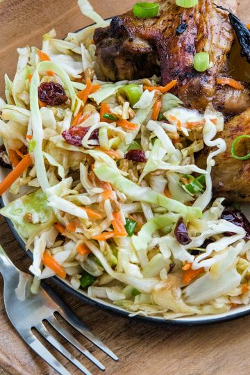 Midwest Cabbage Salad is a cold and crisp side dish made with shredded cabbage, green onions, dried cranberries, almonds. sunflower seeds and sweet dressing is fresh, healthy and stays crunchy in the refrigerator for several days! #mustlovehomecooking