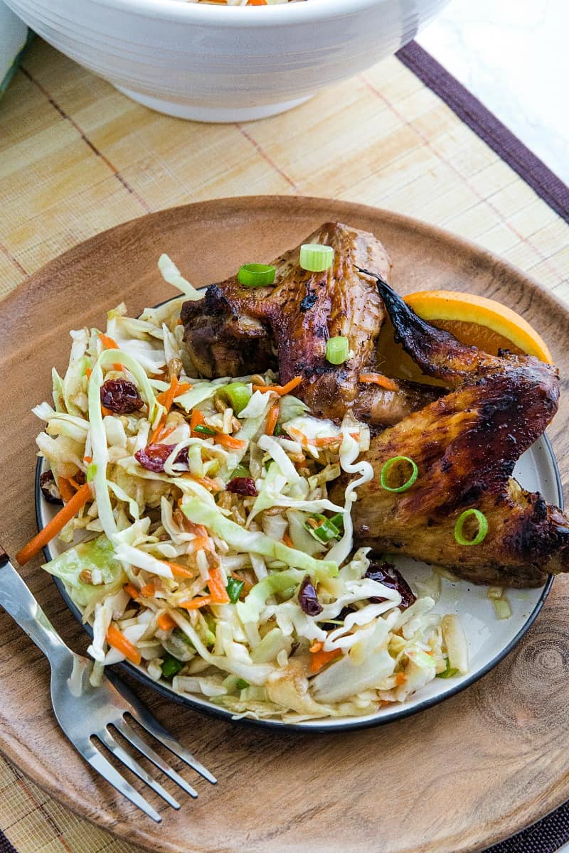 Midwest Cabbage Salad is a cold and crisp side dish made with shredded cabbage, green onions, dried cranberries, almonds. sunflower seeds and sweet dressing is fresh, healthy and stays crunchy in the refrigerator for several days! #mustlovehomecooking