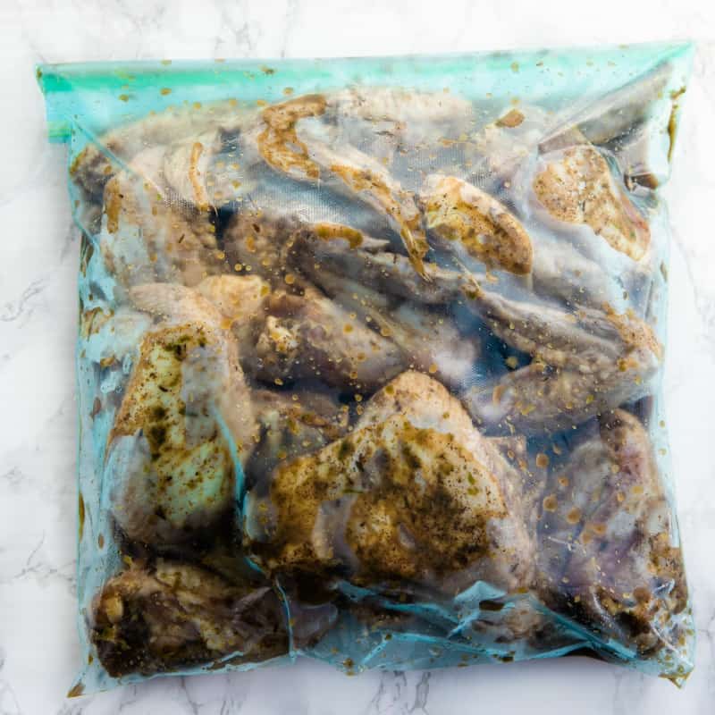 Chicken wings marinating in a plastic bag.