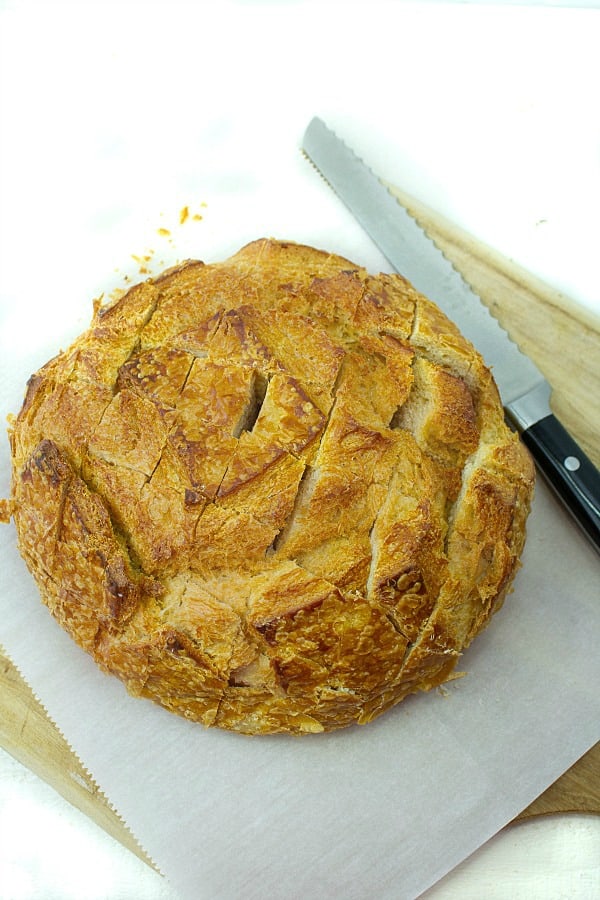 Pull apart three cheese garlic bread is a round sourdough loaf drizzled with garlic butter and stuffed with melting cheese. Crusty, and gooey hot bread made easy in under 30 minutes. #mustlovehomecooking