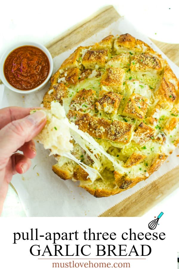 Pull apart three cheese garlic bread is a round sourdough loaf drizzled with garlic butter and stuffed with melting cheese. Crusty, and gooey hot bread made easy in under 30 minutes. #mustlovehomecooking