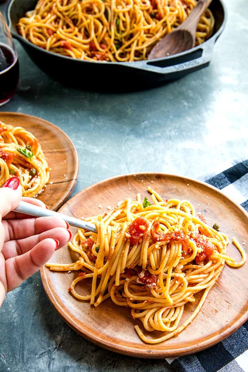 Sun Dried Tomato Puttanesca with tomatoes, anchovies and capers is super fragrant and bursting with flavor...an Italian original made with simple pantry ingredients. #mustlovehomecooking