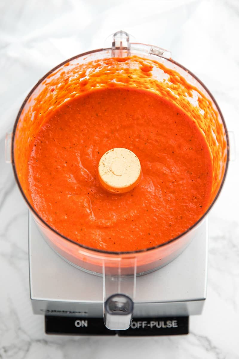 Easy Smooth Romesco Sauce with roasted red peppers. tomato, almonds and garlic. A bold snappy sauce perfect for pasta, chicken, eggs and more.