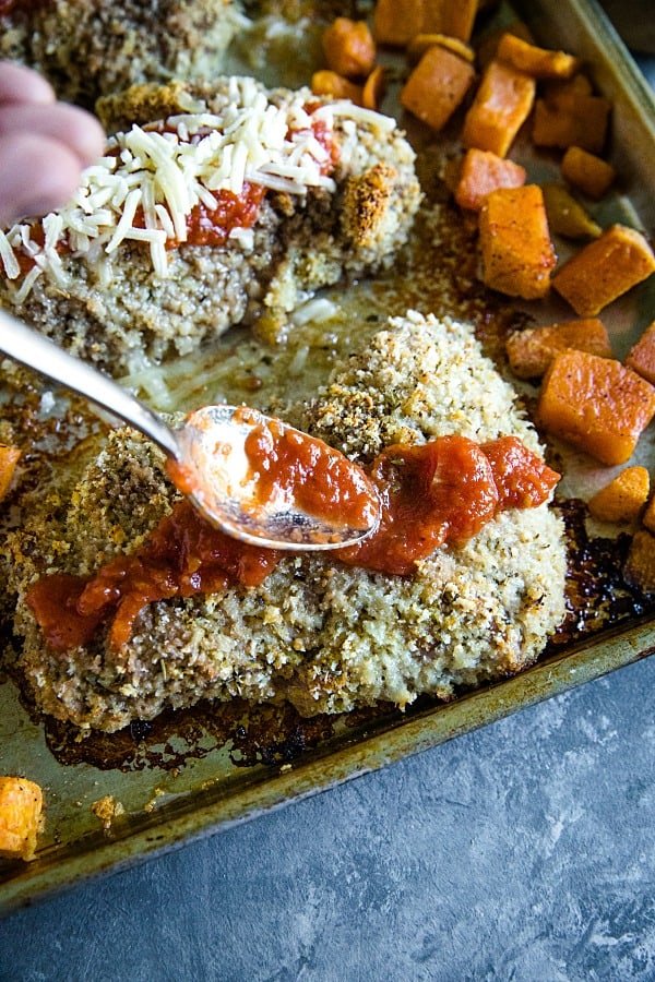 Oven baked crusted pork chops spooned with marinara sauce