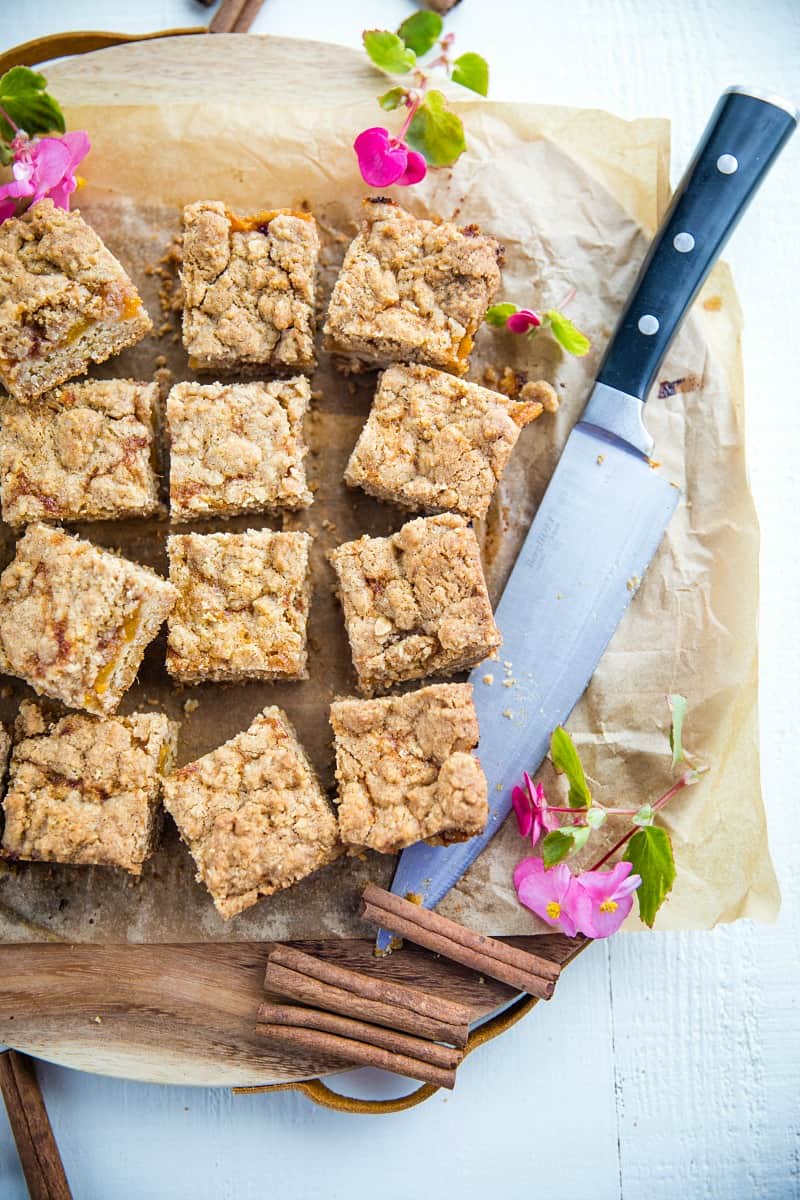 Buttery and decadent, these simple Cinnamon Spice Peach Crumb Bars with oats and spice are just in time for this seasonal fruit.