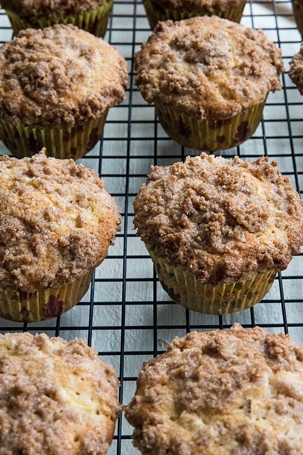 The BEST cinnamon spice apple muffins are filled with fresh apples, and piled high with a crisp, buttery crumb layer.