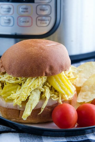 Tangy and flavorful shredded chicken, made with banana peppers and ranch seasoning, ready in minutes from your pressure cooker. #mustlovehomecooking