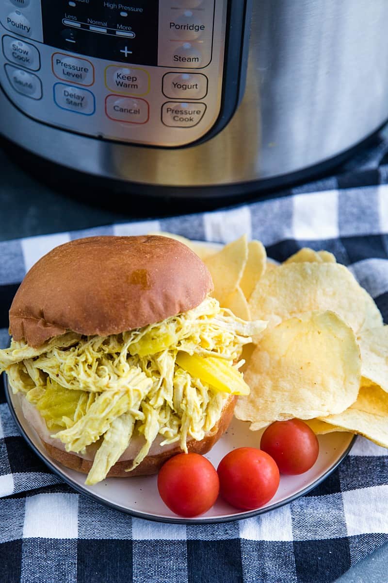 Tangy and flavorful shredded chicken, made with banana peppers and ranch seasoning, ready in minutes from your pressure cooker. #mustlovehomecooking