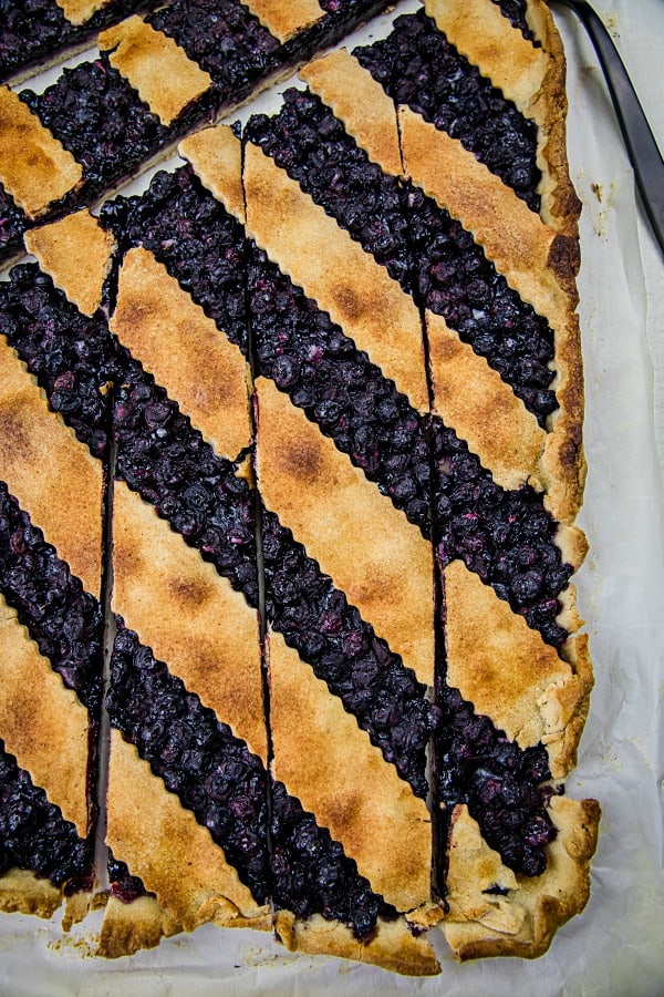 Blueberry Slab Pie is fresh blueberries, cinnamon and lemon juice baking into a buttery and crisp shortbread crust. Easily cuts into bars and feeds a crowd! #mustlovehomecooking