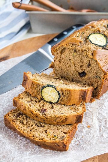 Super moist, buttery quick bread made with tangy sour cream and chock full of raisins, nuts and healthy shredded zucchini. #mustlovehomecooking