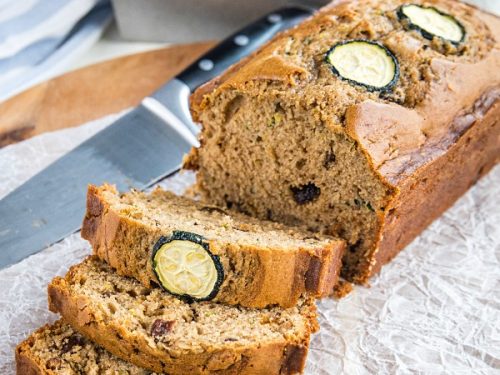 Super moist, buttery quick bread made with tangy sour cream and chock full of raisins, nuts and healthy shredded zucchini. #mustlovehomecooking
