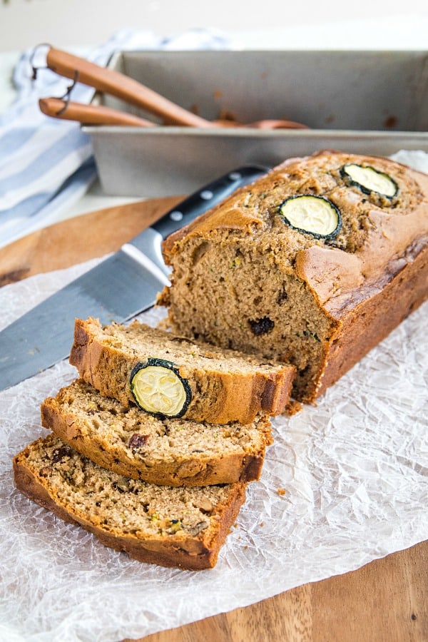 Super moist, buttery quick bread made with tangy sour cream and chock full of raisins, nuts and healthy shredded zucchini. #mustlovehomecooking