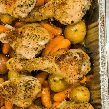 Baked up juicy and full of garden herb flavor, this freezer meal with chicken drumsticks, potatoes, carrots and savory sauce is a tasty family favorite. #mustlovehomecooking