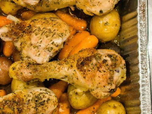 Baked up juicy and full of garden herb flavor, this freezer meal with chicken drumsticks, potatoes, carrots and savory sauce is a tasty family favorite. #mustlovehomecooking