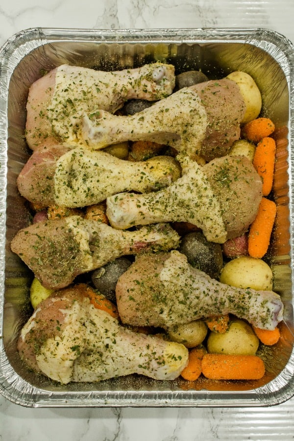 herb chicken drumsticks in foil pan ready for the freezer 