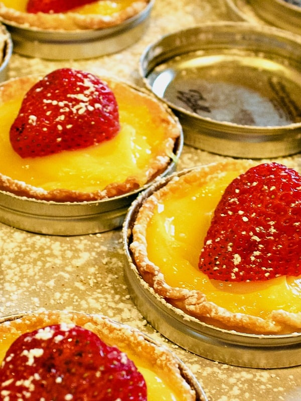 Cool, tangy and dotted with fresh strawberry this simple mini lemon tart dessert takes only 4 easy ingredients and no special pans to make them! #mustlovehomecooking