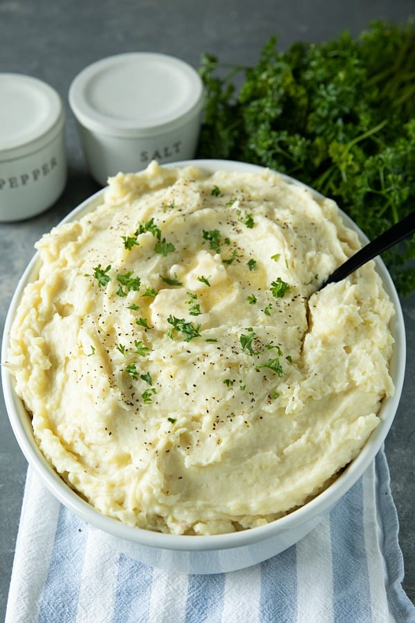 Make Ahead Mashed Potatoes are simple, creamy and so flavorful, made easy with baked potatoes. No peeling or boiling needed. Great for the busy holidays! #mustlovehomecooking